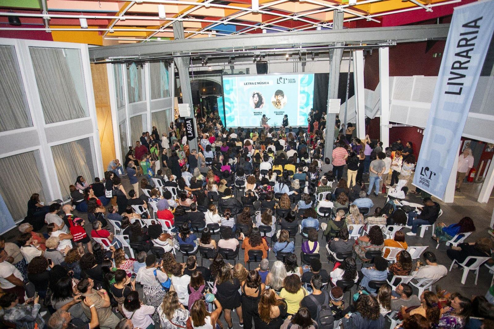 Packed arena during a talk