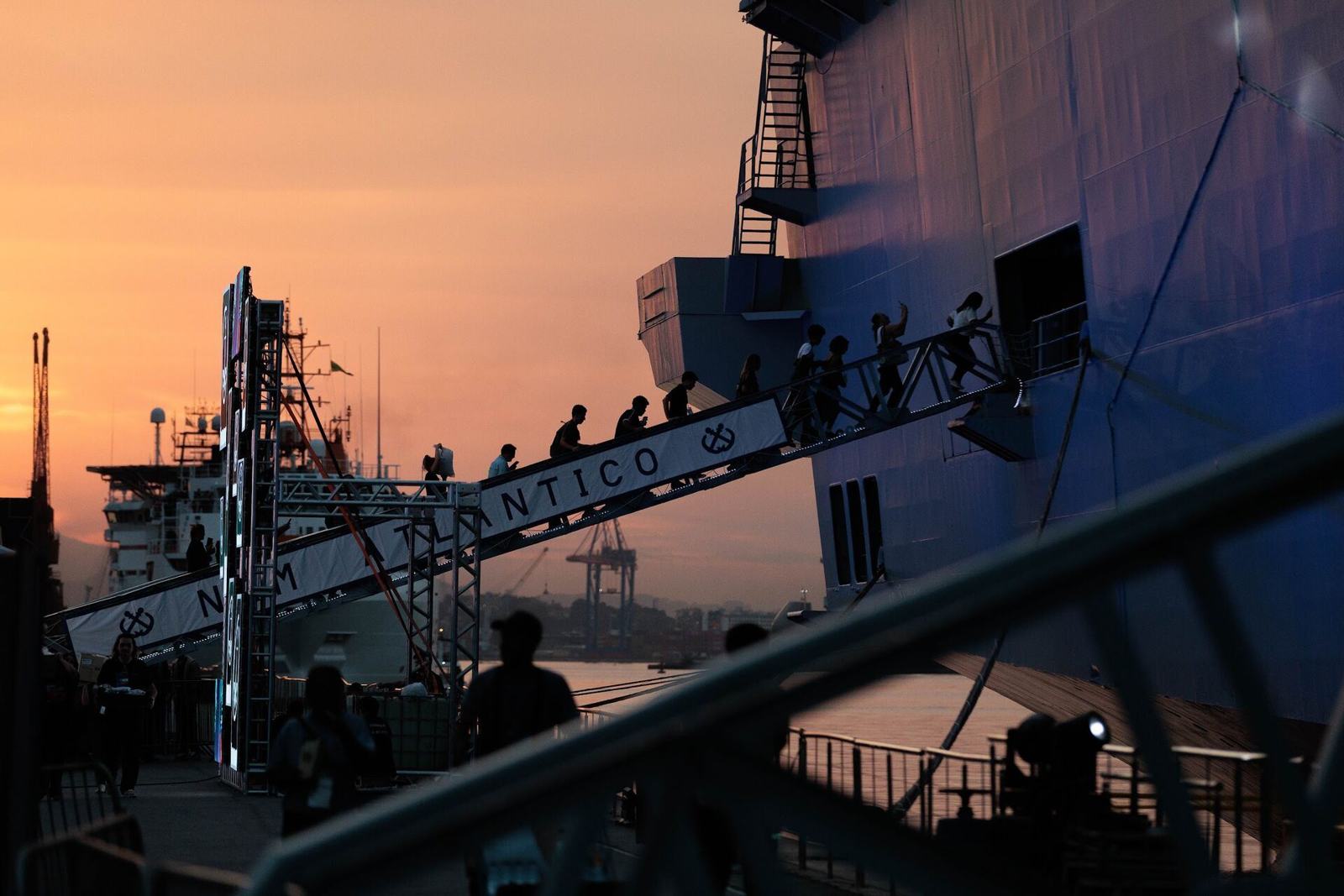 Visitors on the NAM Atlântico gangway at dusk